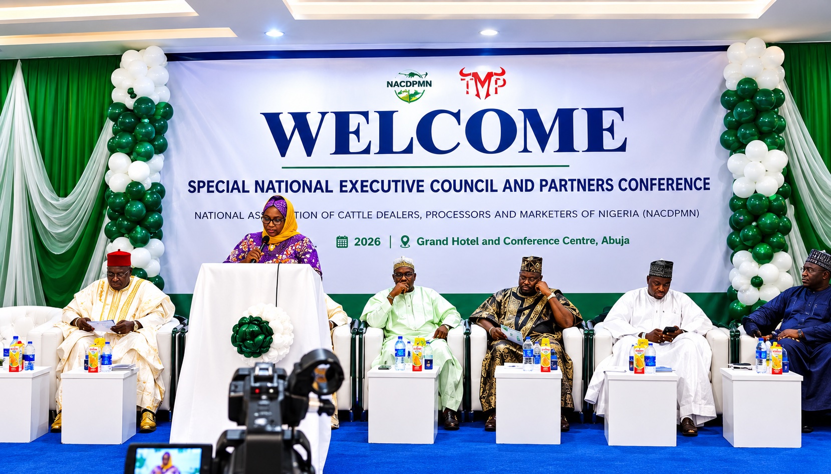 A speaker at a lectern with seated participants and the NACDPMN conference backdrop.